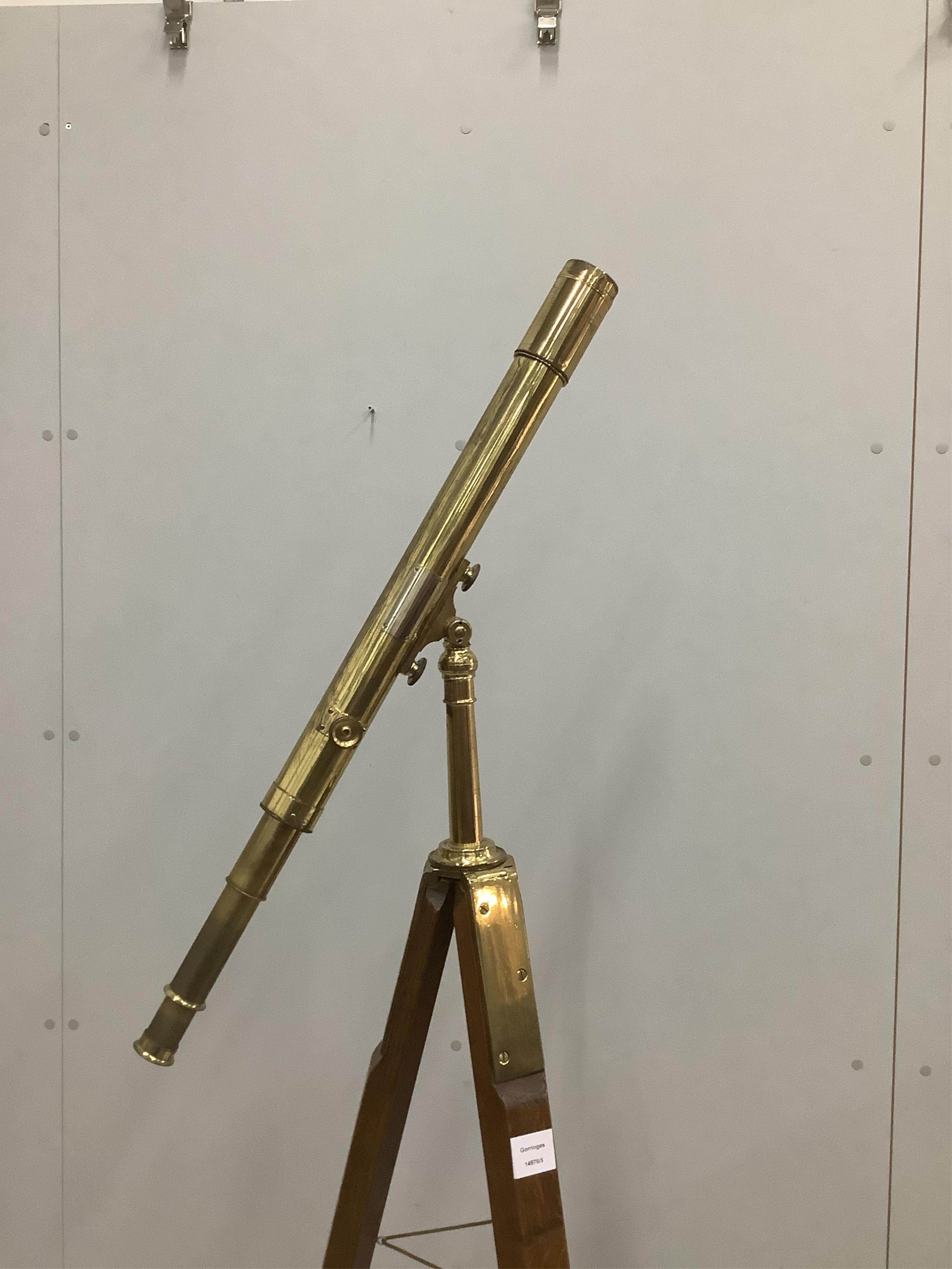 A late 19th century brass two draw telescope, by J. H. Steward, on oak tripod stand, 56cm. Condition - fair, some parts seized